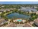 Aerial view of the community showcasing a lake, pool, surrounding apartments and lush landscaping at 5144 City St # 238, Orlando, FL 32839