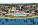Aerial view of community features lush landscaping, palm trees, and a glistening lake at 5144 City St # 238, Orlando, FL 32839
