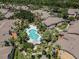 Aerial shot showcases a stunning community pool surrounded by palm trees and well-manicured landscaping at 5144 City St # 238, Orlando, FL 32839