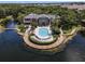 Expansive aerial view showcasing the pool, clubhouse, and lake, surrounded by lush landscaping and walkways at 5144 City St # 238, Orlando, FL 32839