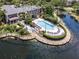 Aerial view of a luxurious community with a pool and spa, surrounded by a wooden deck and beautiful lake at 5144 City St # 238, Orlando, FL 32839