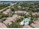 An aerial view features the apartment buildings, mature landscaping, and community pool at 5144 City St # 238, Orlando, FL 32839