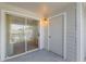 Private balcony featuring sliding glass doors, light fixture, and a storage room at 5144 City St # 238, Orlando, FL 32839