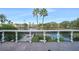 Scenic balcony view overlooking a serene lake, lush landscaping, and distant buildings at 5144 City St # 238, Orlando, FL 32839