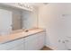 Bathroom featuring white cabinets, a large mirror, and vanity lighting at 5144 City St # 238, Orlando, FL 32839