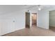 Upstairs bedroom featuring wood-look floors, ceiling fan, closet, and access to the bathroom at 5144 City St # 238, Orlando, FL 32839