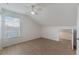 Upstairs bedroom featuring wood-look floors, ceiling fan, window, and closet at 5144 City St # 238, Orlando, FL 32839