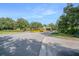 Community entrance with mature trees and landscaped median leading into the neighborhood at 5144 City St # 238, Orlando, FL 32839