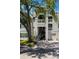 Exterior view of a condo with garages, staircases, and balconies, set against a blue sky at 5144 City St # 238, Orlando, FL 32839