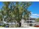 Exterior view of condos featuring garages, balconies, and stairs with landscaping in the front at 5144 City St # 238, Orlando, FL 32839
