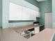 Kitchen featuring white cabinets, a stainless steel sink and standard appliances at 5144 City St # 238, Orlando, FL 32839