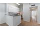 Efficient kitchen featuring white cabinets, gray countertops, and a breakfast bar at 5144 City St # 238, Orlando, FL 32839