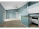 Living room with high ceilings, ceiling fan, and kitchen view with sliding doors to the patio at 5144 City St # 238, Orlando, FL 32839