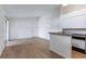 Spacious living room with wood-look floors, access to the kitchen, and front door entry at 5144 City St # 238, Orlando, FL 32839