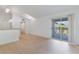 Bright living room featuring wood-look floors, skylight, and sliding glass doors to the balcony at 5144 City St # 238, Orlando, FL 32839