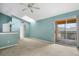 Living room with sliding glass doors to balcony, a ceiling fan, and a skylight at 5144 City St # 238, Orlando, FL 32839