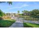 Scenic pond view with a charming gazebo, lush landscaping, and a wooden walkway at 5144 City St # 238, Orlando, FL 32839