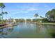 Wide view of a tranquil pond featuring a gazebo and lush tropical foliage on a clear day at 5144 City St # 238, Orlando, FL 32839