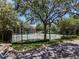 Well-maintained tennis courts nestled in lush greenery, offering a serene spot for recreational activities at 5144 City St # 238, Orlando, FL 32839