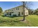 Spacious backyard with lush green grass, back of house, screened in porch, and manicured landscaping at 612 Old Pine Ct, Sanford, FL 32773