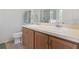 Bathroom featuring double sink vanity with traditional cabinets, lighting, and decor at 612 Old Pine Ct, Sanford, FL 32773