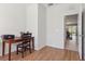 Bedroom furnished with a wood desk, computer, and chair, and view to another room, ideal for students or professionals at 612 Old Pine Ct, Sanford, FL 32773