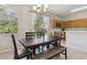 Bright dining area with a view of the kitchen, natural light, and modern chandelier, ideal for Gathering gatherings at 612 Old Pine Ct, Sanford, FL 32773