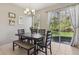 Inviting dining area with sliding glass doors that offer natural light and views of the beautifully landscaped backyard at 612 Old Pine Ct, Sanford, FL 32773