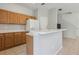 Cozy kitchen featuring wood cabinets, tile flooring, and a breakfast bar, perfect for casual dining and entertaining at 612 Old Pine Ct, Sanford, FL 32773