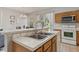 Well-maintained kitchen with stainless steel sink and wood cabinets at 612 Old Pine Ct, Sanford, FL 32773