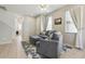 Spacious living room offering natural light and a cozy gray sofa, perfect for relaxing with Gathering and friends at 612 Old Pine Ct, Sanford, FL 32773