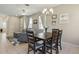 Comfortable living room featuring a plush gray sofa, and an open concept dining room and kitchen, ideal for relaxation at 612 Old Pine Ct, Sanford, FL 32773