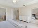 View of the main bedroom into en-suite bathroom with a white dresser and neutral colors at 612 Old Pine Ct, Sanford, FL 32773
