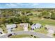 Serene aerial view showcasing a charming residential neighborhood nestled amongst lush greenery and adjacent to golf course at 6133 Seagull Ln, Lakeland, FL 33809