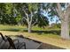 Enjoy the serene view from the backyard, overlooking lush greenery, mature trees, and a pond on the golf course at 6133 Seagull Ln, Lakeland, FL 33809