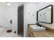Bright bathroom boasts glass enclosed shower and modern sink with black faucet at 6133 Seagull Ln, Lakeland, FL 33809
