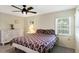 Cozy bedroom with a ceiling fan, carpet, and bright windows at 6133 Seagull Ln, Lakeland, FL 33809