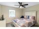 Cozy bedroom featuring a ceiling fan, window, television, and vibrant bedspread at 6133 Seagull Ln, Lakeland, FL 33809