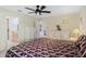 Bright bedroom features ceiling fan, ensuite bathroom, and comfortable furnishings at 6133 Seagull Ln, Lakeland, FL 33809