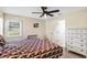 Bedroom with ceiling fan and window providing natural light, next to a dresser at 6133 Seagull Ln, Lakeland, FL 33809