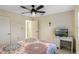 Bedroom with ceiling fan, television, and desk at 6133 Seagull Ln, Lakeland, FL 33809