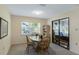 Bright dining room with an oak table and chairs, and a large window with backyard views at 6133 Seagull Ln, Lakeland, FL 33809