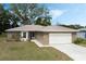 Charming single-story home with a well-manicured lawn, two car garage and mature trees at 6133 Seagull Ln, Lakeland, FL 33809