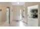 Bright foyer with tile flooring, leading to kitchen and laundry room at 6133 Seagull Ln, Lakeland, FL 33809