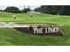 Scenic golf course view featuring manicured greens, water feature, and golfers enjoying the course at 6133 Seagull Ln, Lakeland, FL 33809