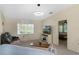 Cozy living room with plush seating, a modern light fixture, and a view into the bedroom at 6133 Seagull Ln, Lakeland, FL 33809