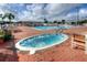Resort-style pool area includes a hot tub and lounge chairs for relaxing in the sun at 6133 Seagull Ln, Lakeland, FL 33809