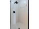 Shower with white tile and black shower head at 6133 Seagull Ln, Lakeland, FL 33809