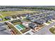 Aerial view showcases community amenities including a pool, bocce ball court, tennis court, and surrounding homes at 7699 Sw 74Th Loop, Ocala, FL 34481