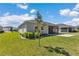 A well-maintained backyard featuring a covered lanai and a neatly paved patio at 7699 Sw 74Th Loop, Ocala, FL 34481
